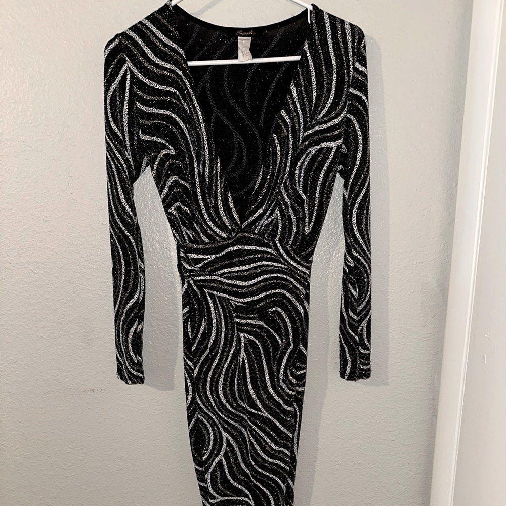 Party cocktail dress, worn only two times, black, silver,& white in color.